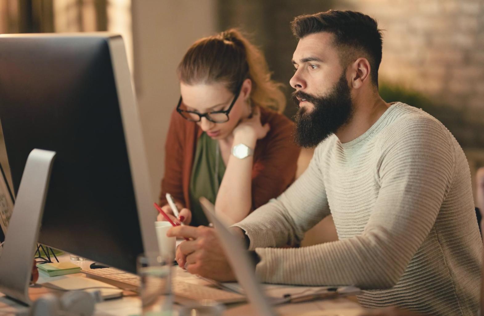 Learning materials organized on desk with notebook and laptop showing content optimization workflows